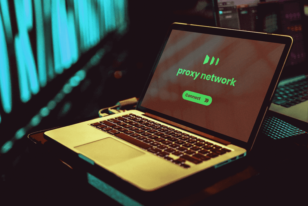 A laptop with the words 'proxy network' illumintated in green on a dark background