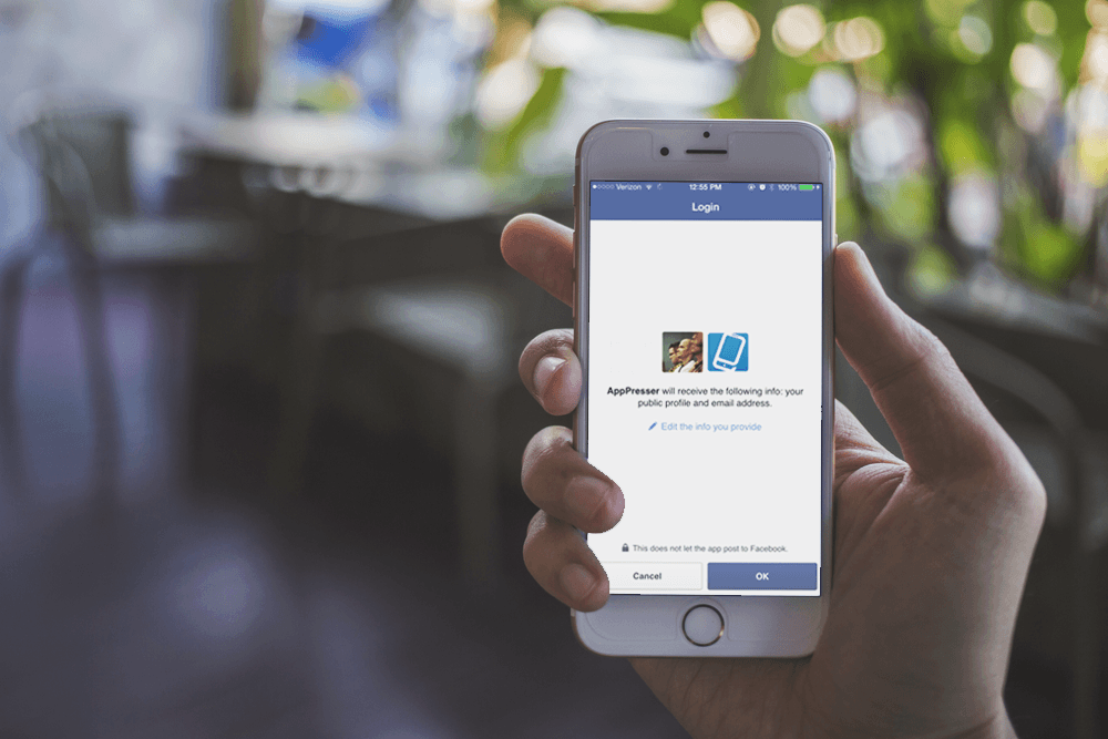 A person holds a phone that is using Facebook Connect to sign in to AppPresser