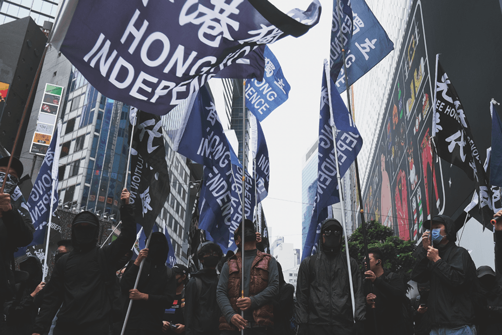 pro-democracy activists in Hong Kong carry flags