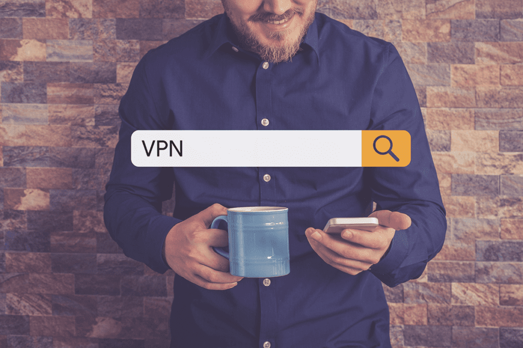 A man's torso is visible while he uses his phone to search the term "VPN"