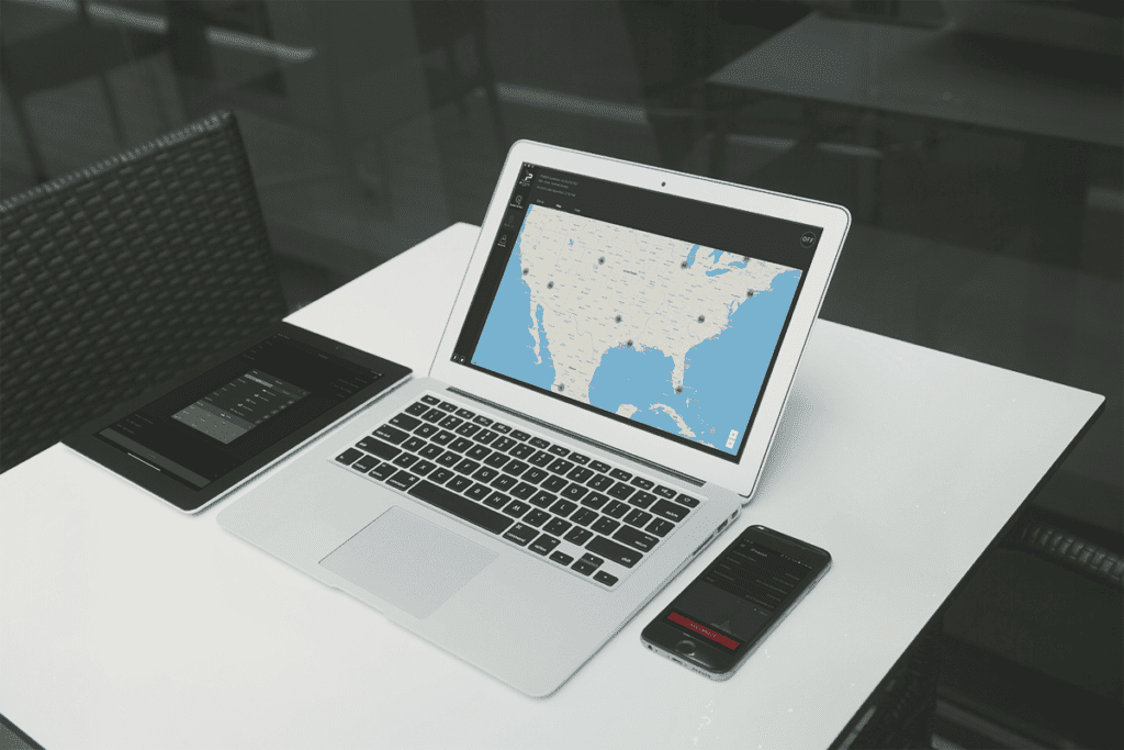 A tablet, smartphone, and laptop rest idle on a table with online privacy app silverbackvpn opened