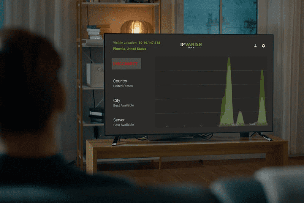 Back of a man sitting on a couch looking at a television that is actively running theSilverBackVPNVPN app on Fire stick