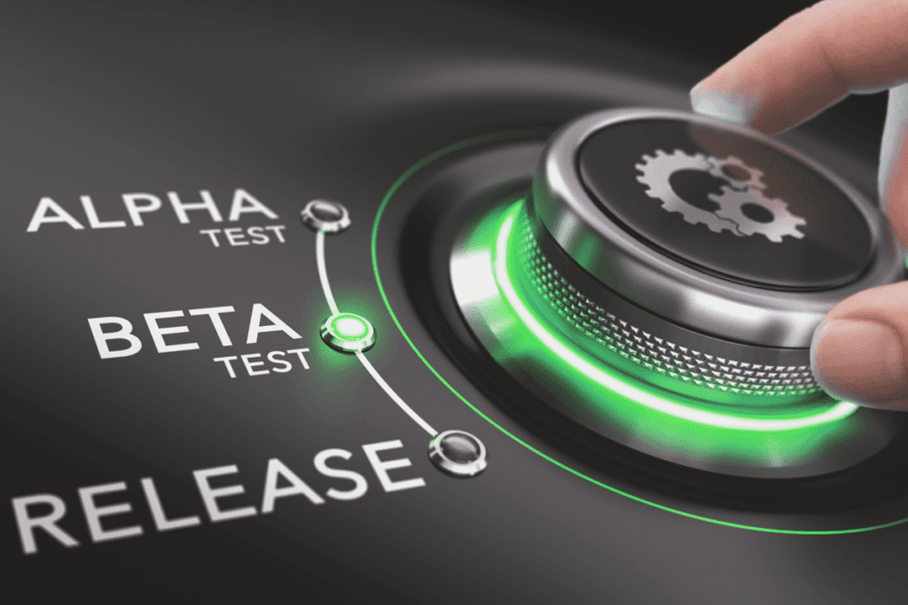 A man's hand rotates a green-glowing dial to 'beta test' for the beta program