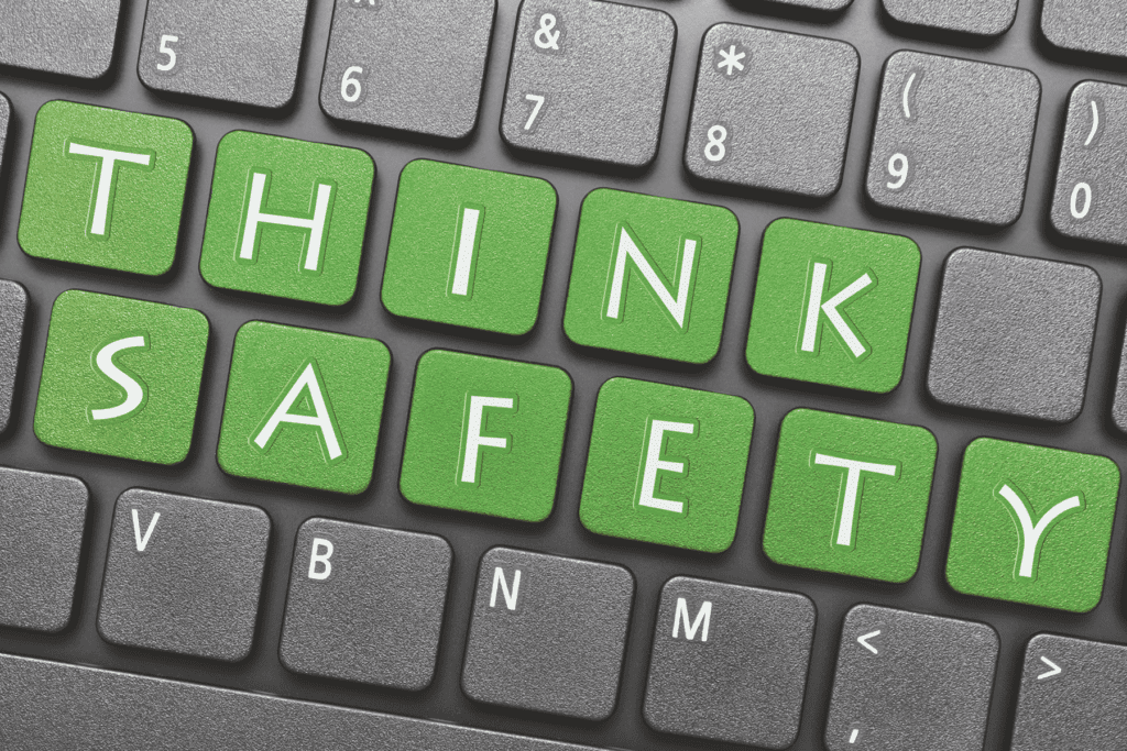 stay safe online concept art. keyboard spells out 'think safety' in green