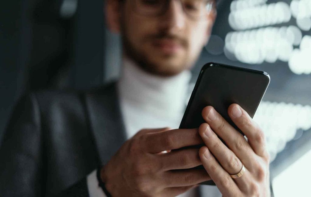 man in a suit looking at his mobile device