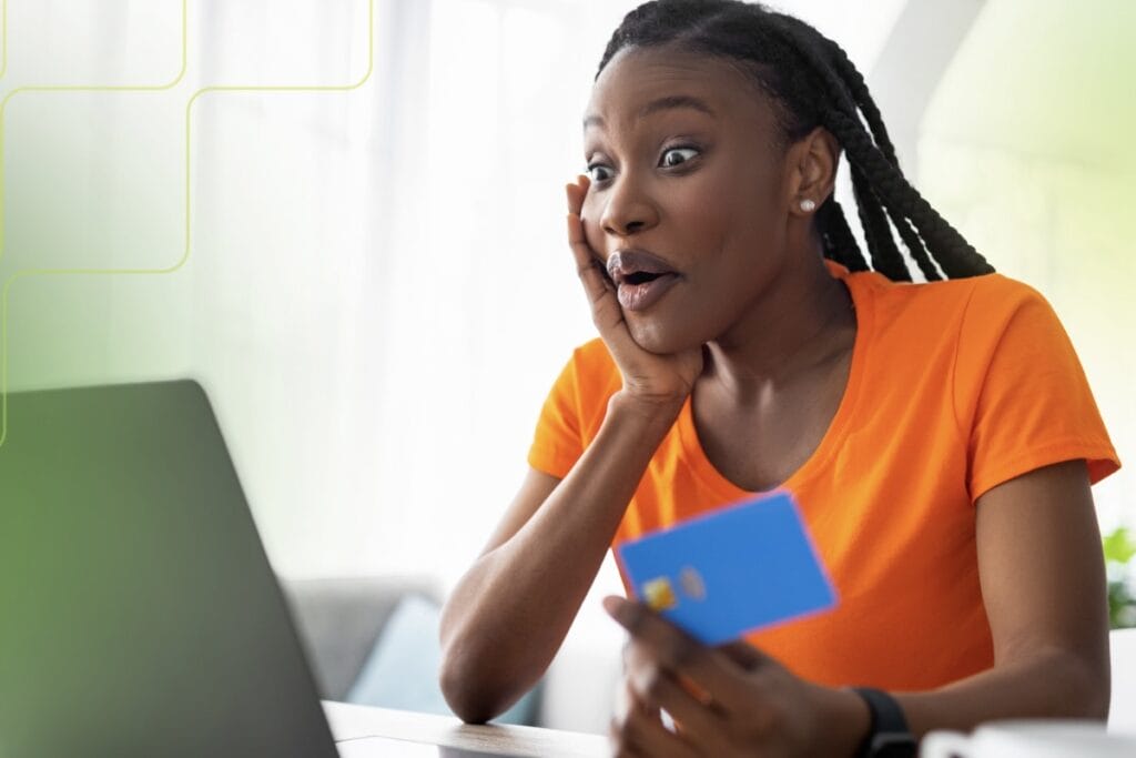 woman on the phone holding a credit card