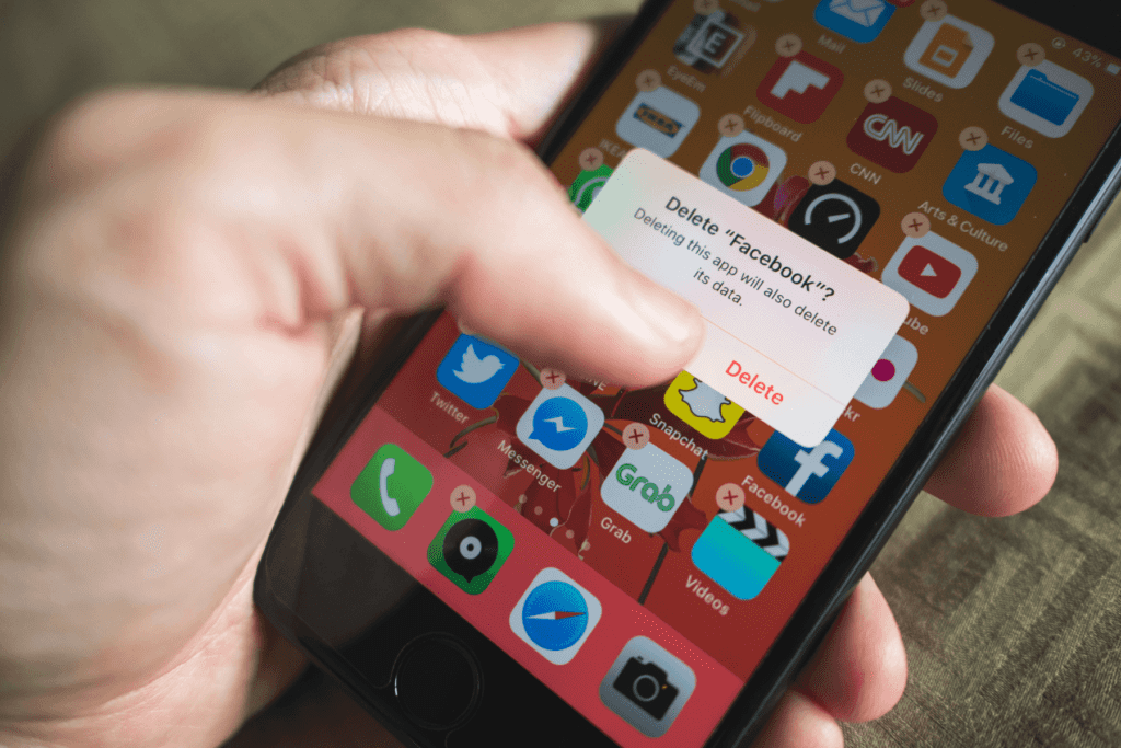 Person uninstalling app from smartphone