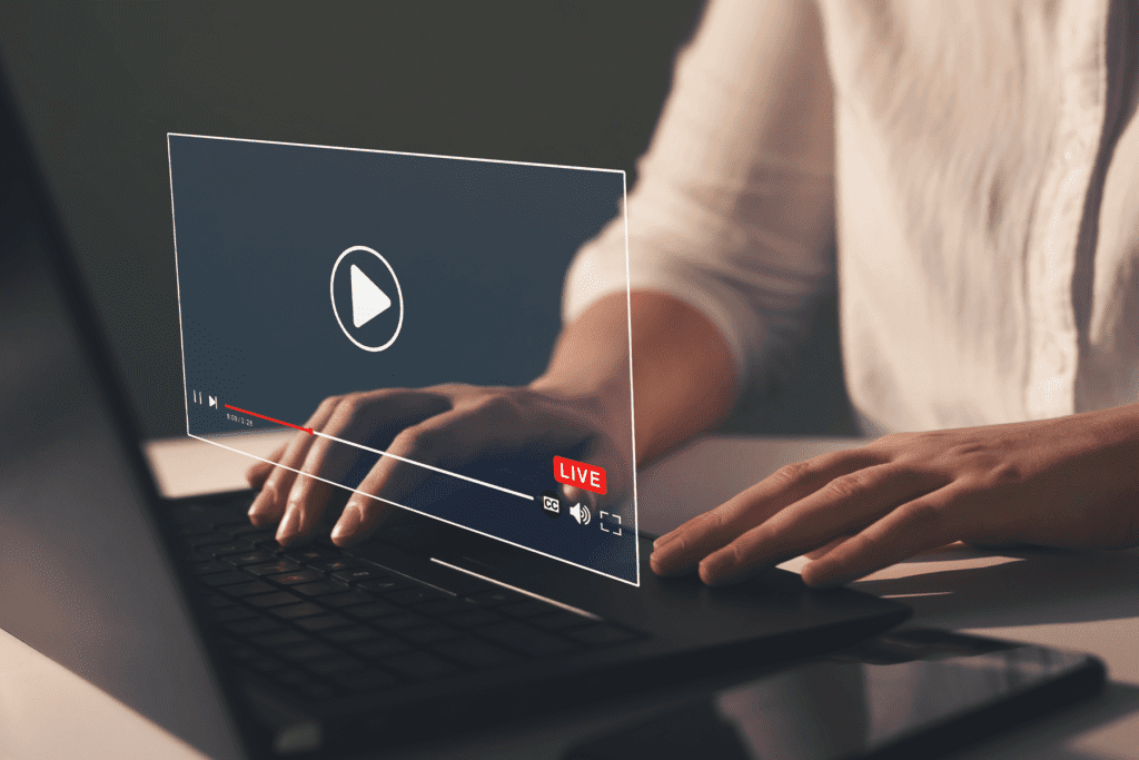 A woman uses a laptop to watch videos. Youtube alternatives visualized in concept image.