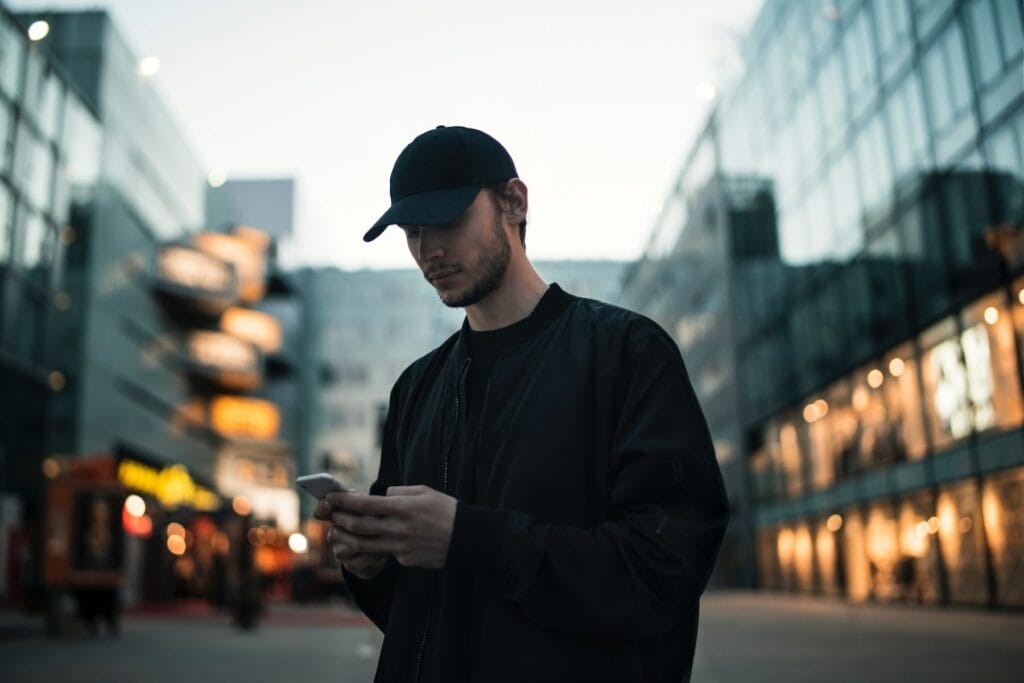 Man texting in city center