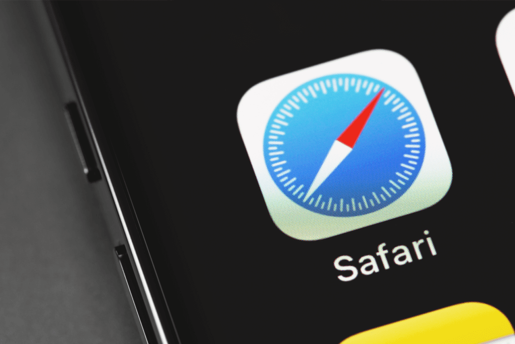 The Safari app icon is displayed on iPhone as a person figures out how to delete Safari
