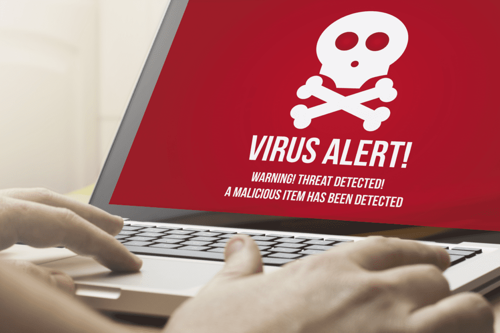 A MacBook computer displays a virus alert, answering the question can Macs get viruses