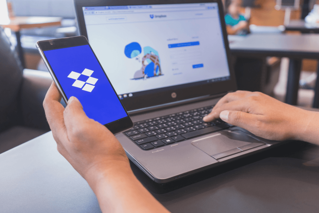 A person is on the Dropbox website and using the app searching for how to delete Dropbox
