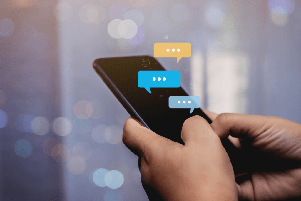 A person holds a phone with a visualization of a messaging conversation to depict the safest chat app