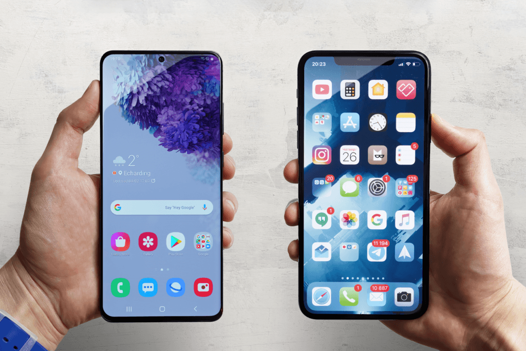 A person holds an Android phone and an iPhone as they learn how to transfer data from Android to iPhone