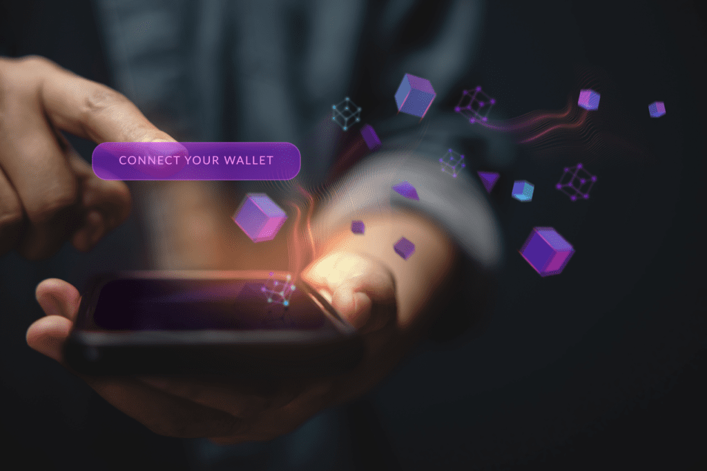 The hands of a person on their phone with illustrations of blocks flying out to demonstrate what is Web3.