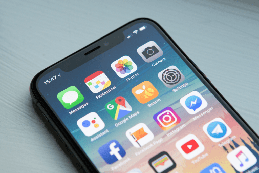 A phone display screen shows multiple apps, decorative visual for how to disable app tracking on iphone