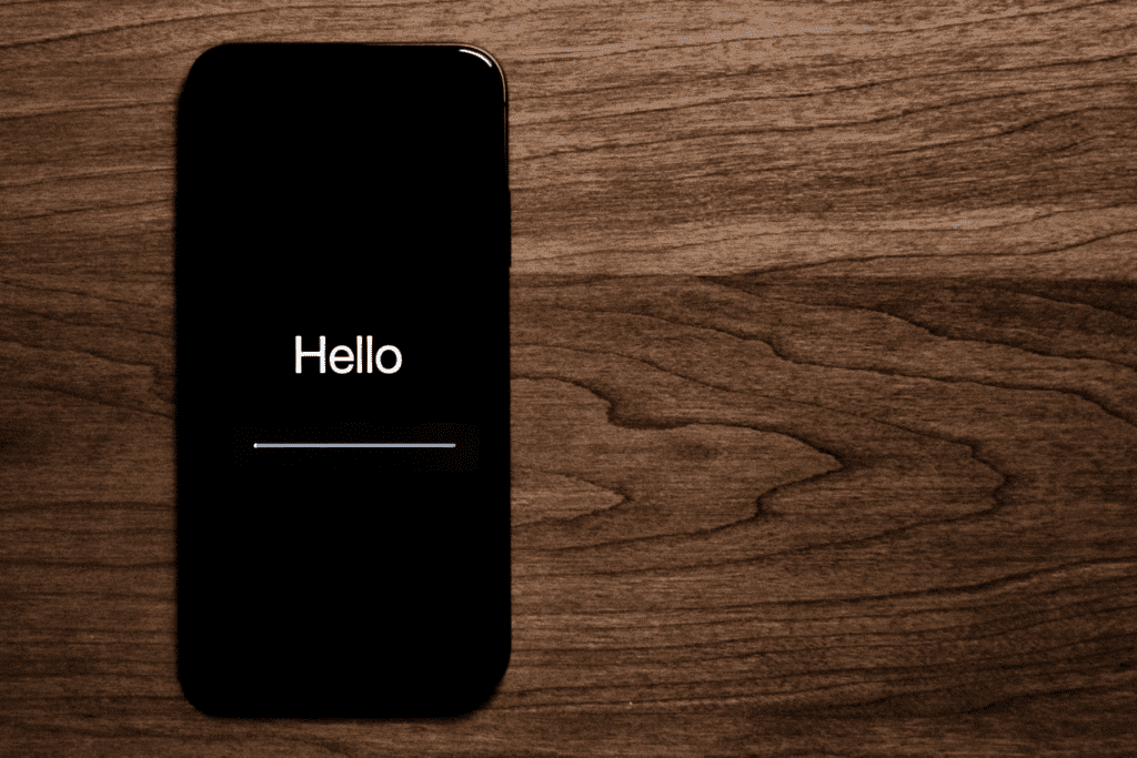 An iPhone is seen starting up after being reset to visualize how to factory reset iPhone devices