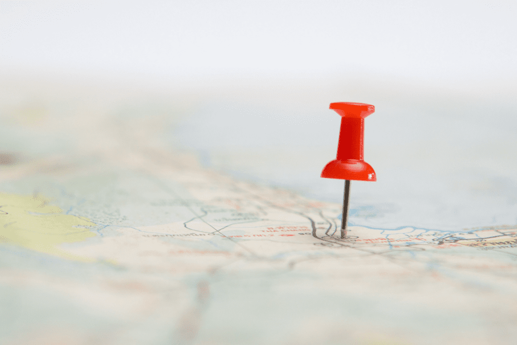 Photo shows a closeup of a pushpin on a map to indicate Precise Location on iPhone