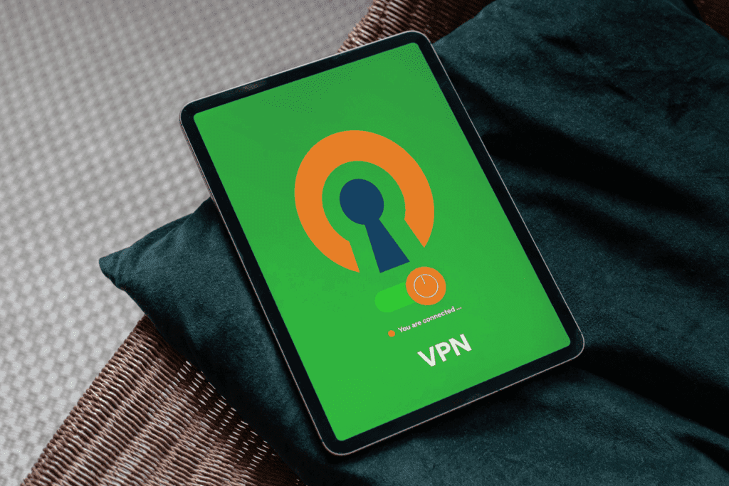 A tablet placed on a couch displays OpenVPN against a green background