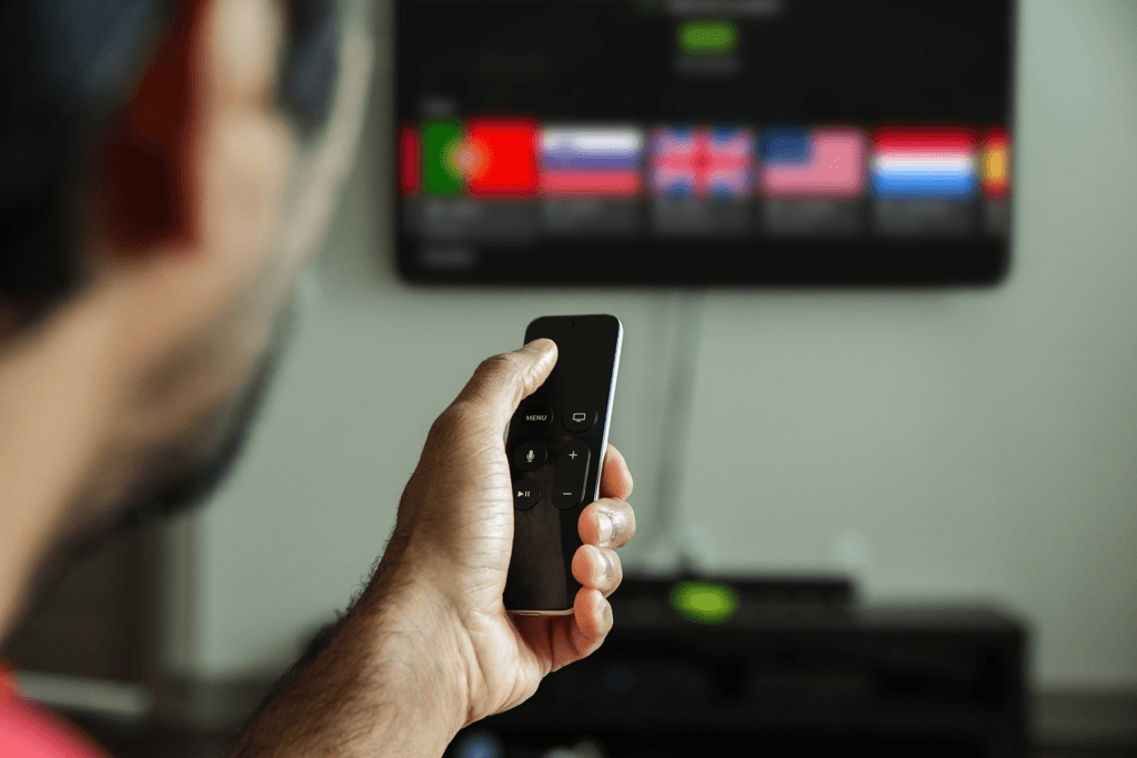 A man is seen using theSilverBackVPNVPN app for Apple TV while holding a remote