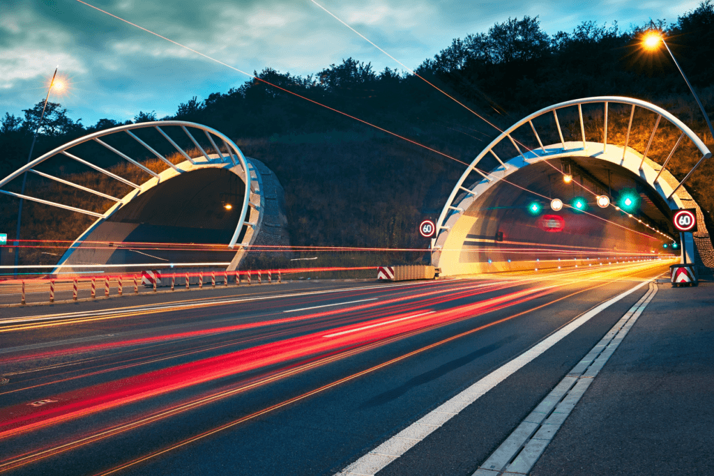 A photo of tunnel entrances side by side with traffic light trails to demonstrate what is split tunneling