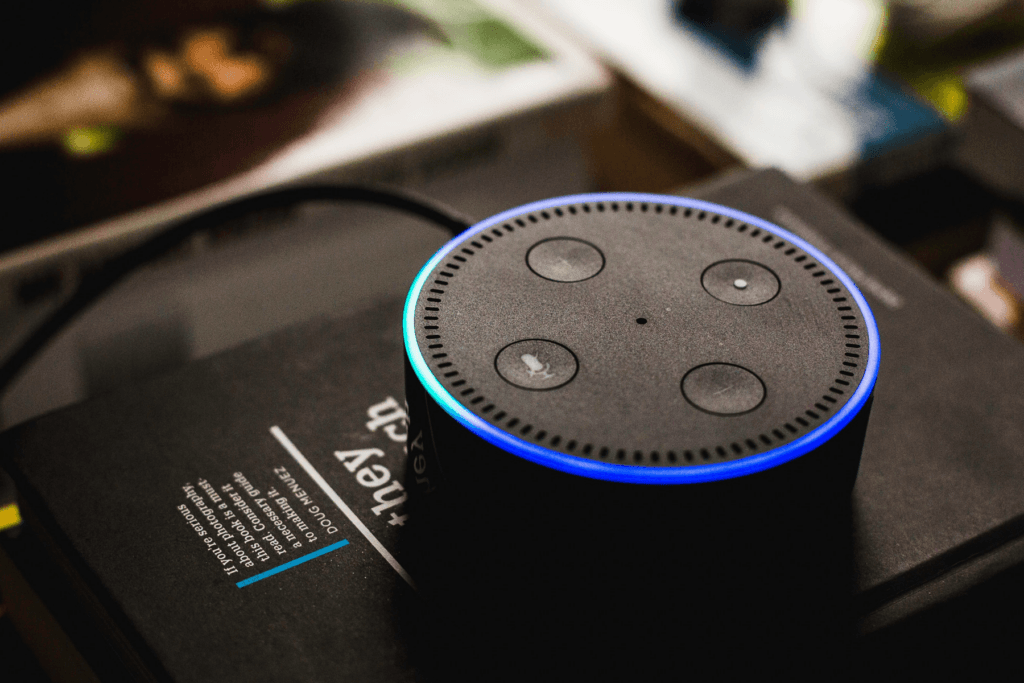 An Amazon Echo Dot is seen with the blue light ring activated. When people see this they ask does Alexa spy on you?