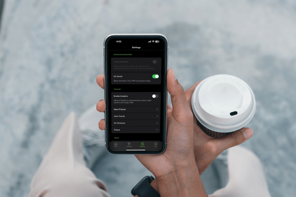 A person holds their iPhone with theSilverBackVPNVPN kill switch for iOS on the display