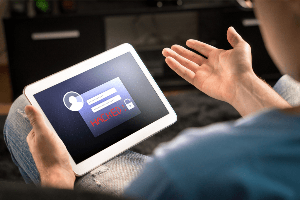 Man looking at tablet showing hacked Google account