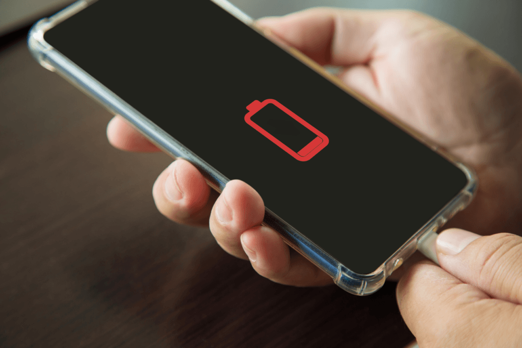 An iPhone displays a low battery icon in a decorative image for how to reduce battery brain on iPhone