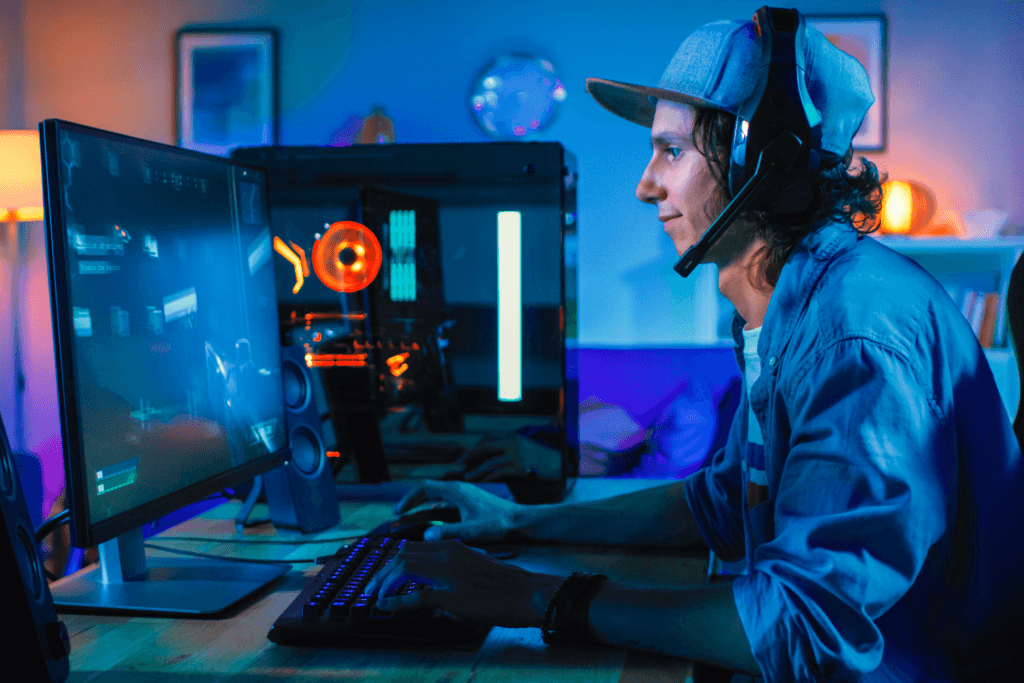 A man sits at a gaming PC; decorative image for how to optimize pc performance with a VPN