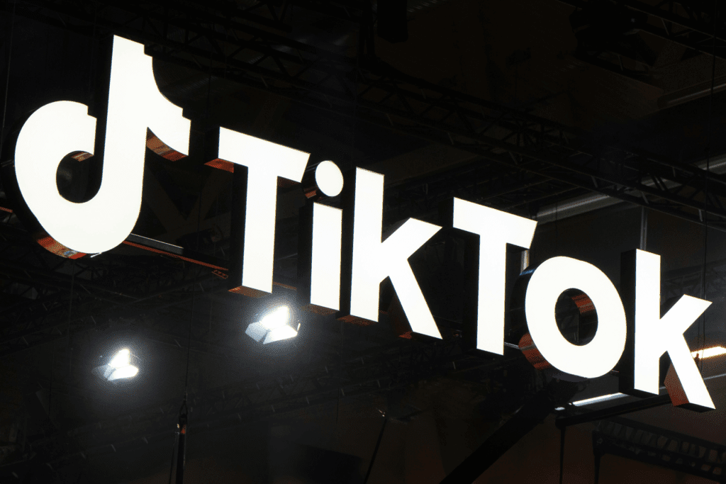 Decorative image for a post that answers the question ' Was my TikTok hacked? ' showing a photo of the TikTok sign on a support truss system