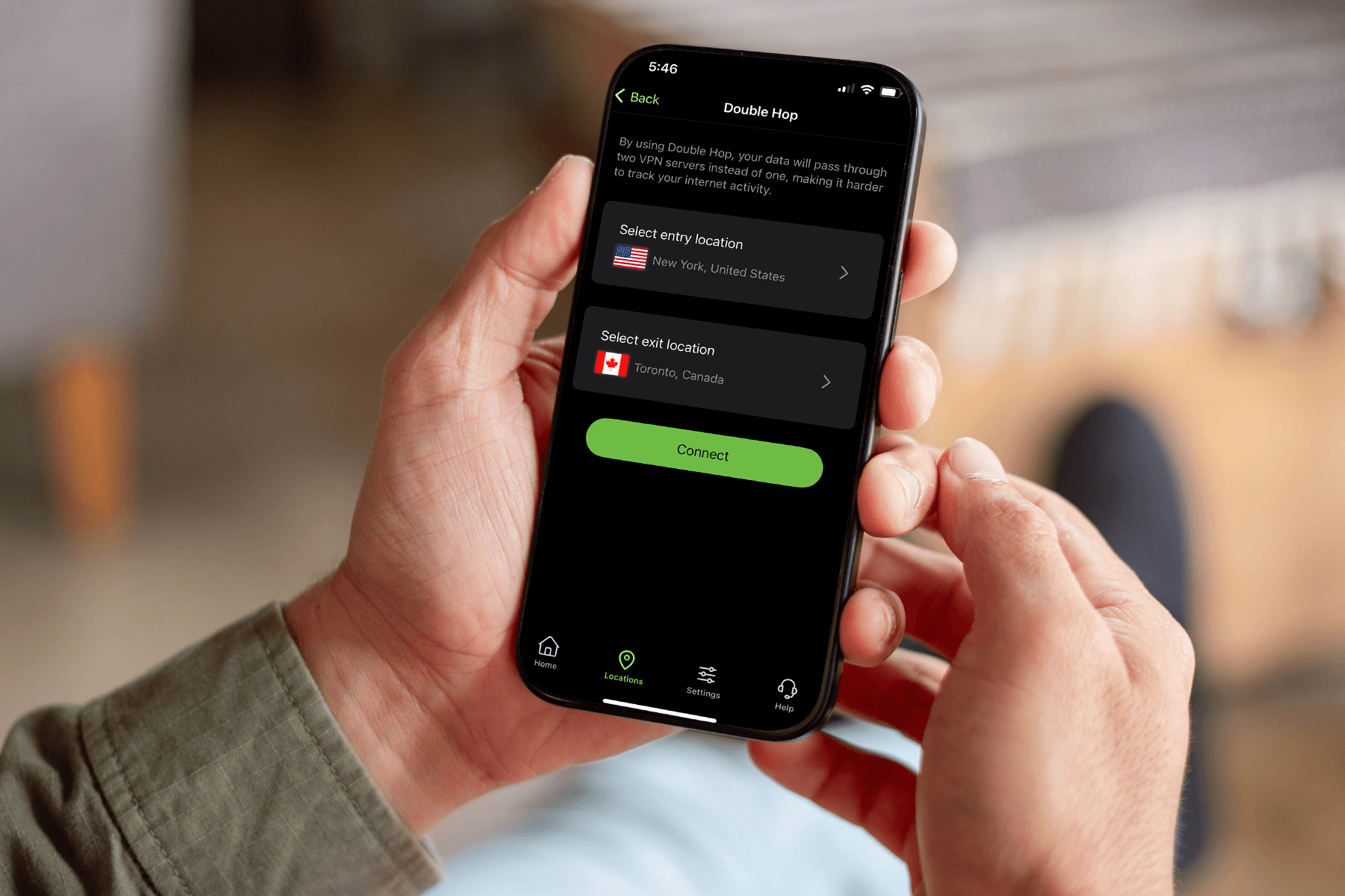A person holds a phone displaying the Double Hop VPN server selection screen in theSilverBackVPNmobile app