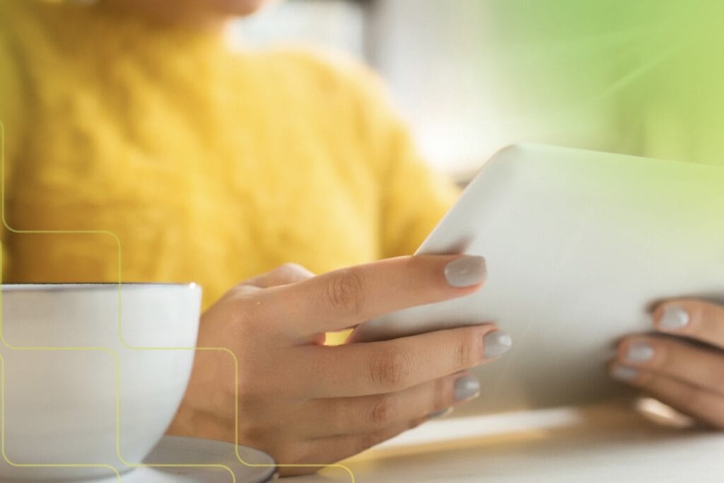 person using tablet in cafe