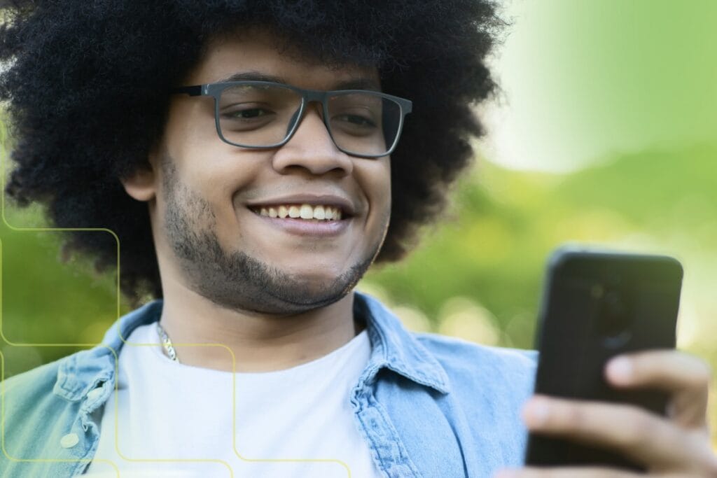 man smiling while using phone