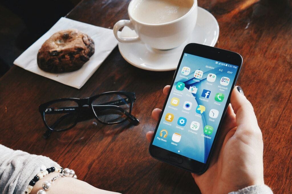 person holding android phone, how to block ads android