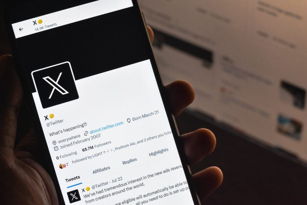 Selective focus of Twitter/X account on a mobile screen. Twitter privacy settings