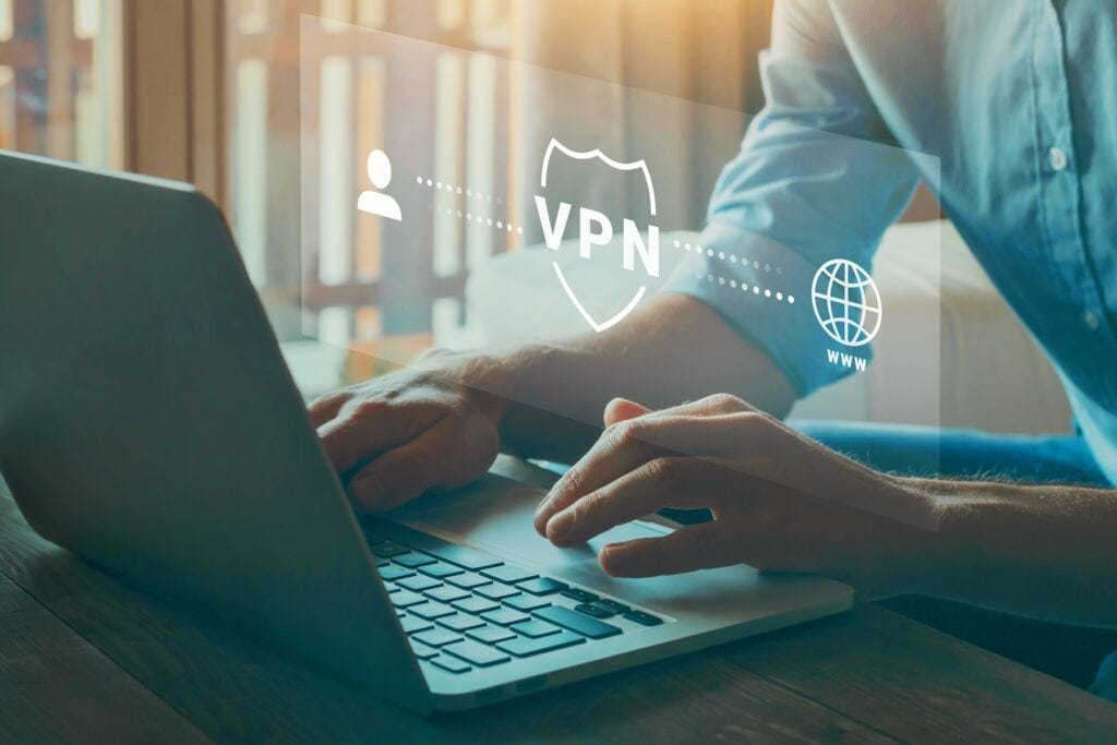 man at computer with a VPN overlay, what does a VPN do