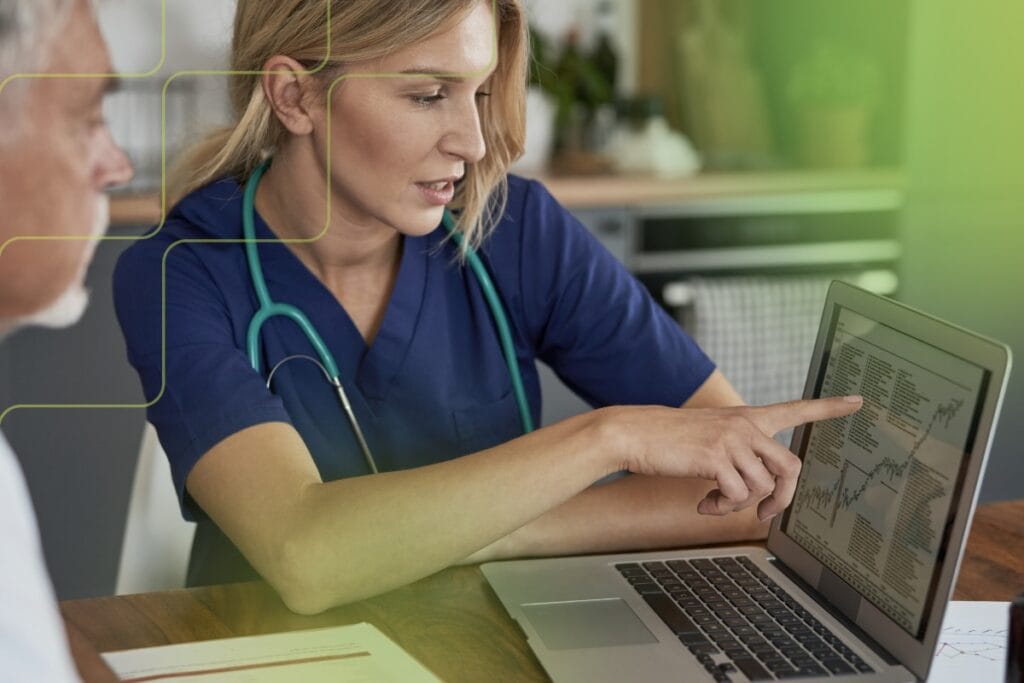 healthcare professional looking at a laptop with a patient, health data