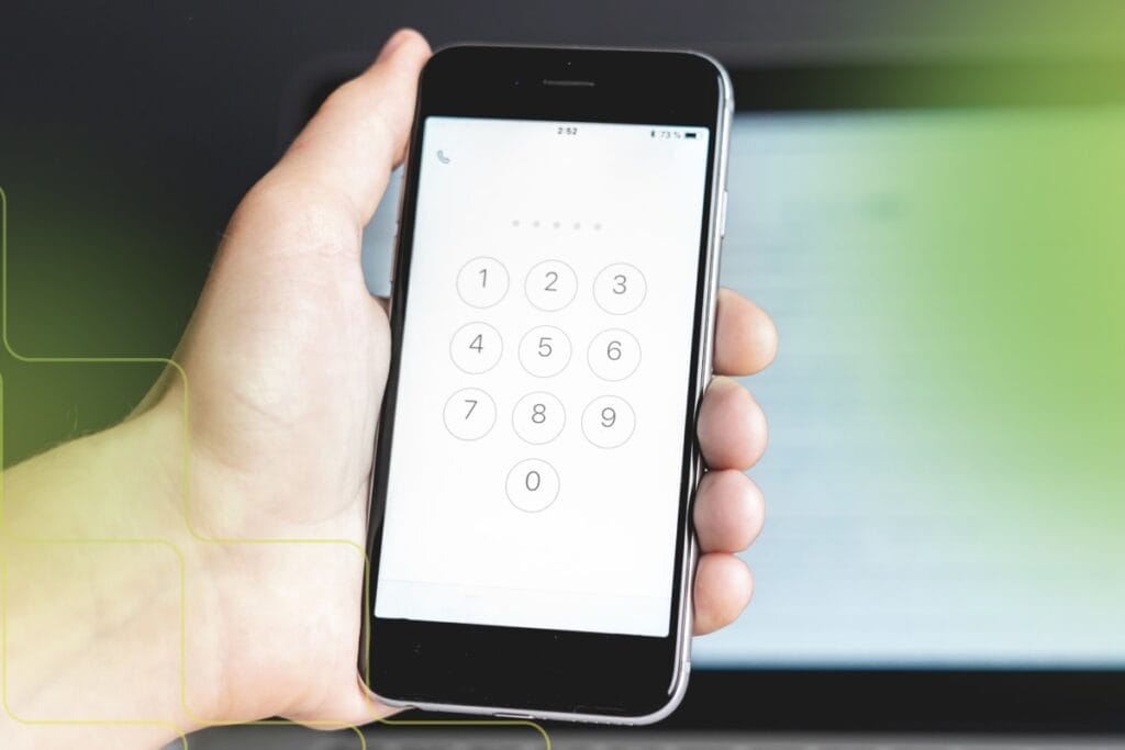 hand holding iPhone with numerical pad displayed