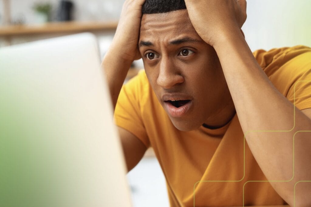 stressed out man sitting in front of a computer