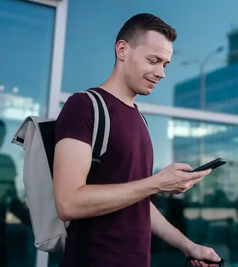 Man at airport using phone