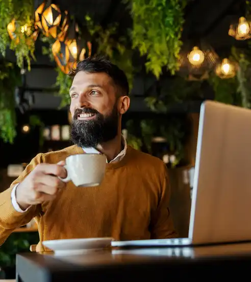 Man in cafe working with laptop