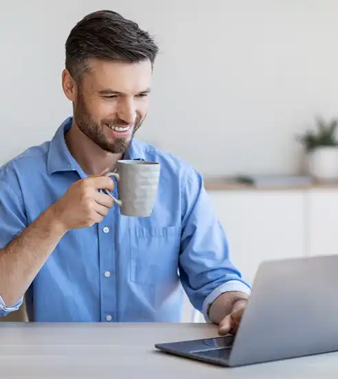 Man working on laptop in coffee shop