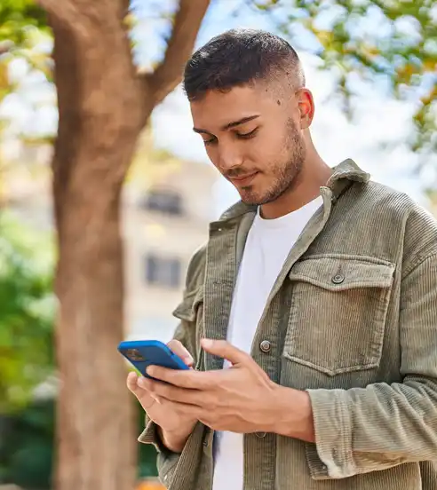Man in the park looking at phone