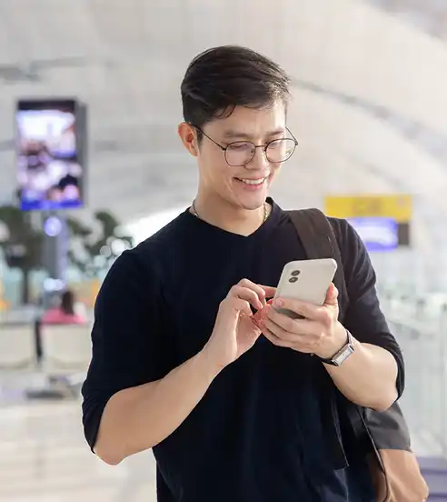 Man at airport looking at phone