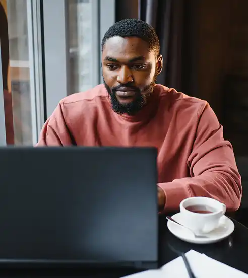 Working at laptop in cafe